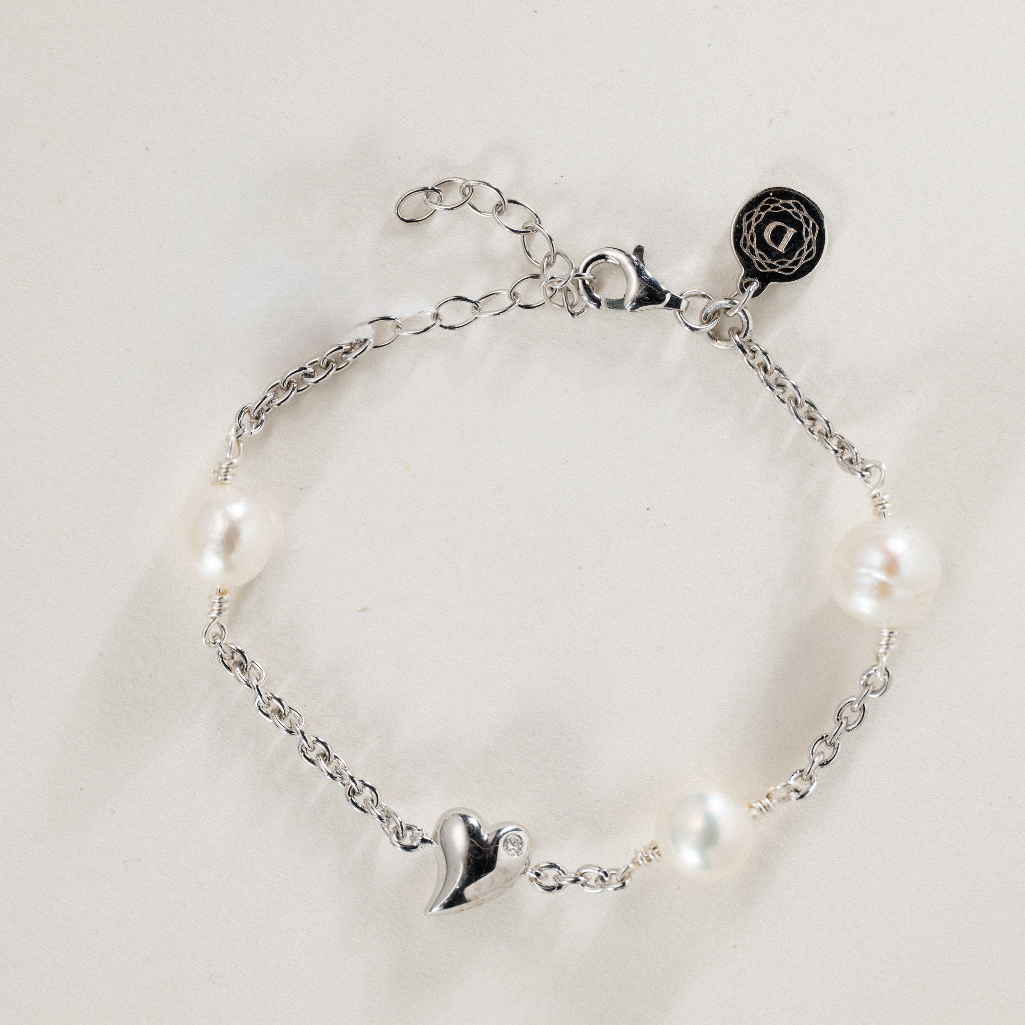 No. 21 - 0.02ct Grown diamond twisted heart & freshwater pearl bracelet in rhodium silver