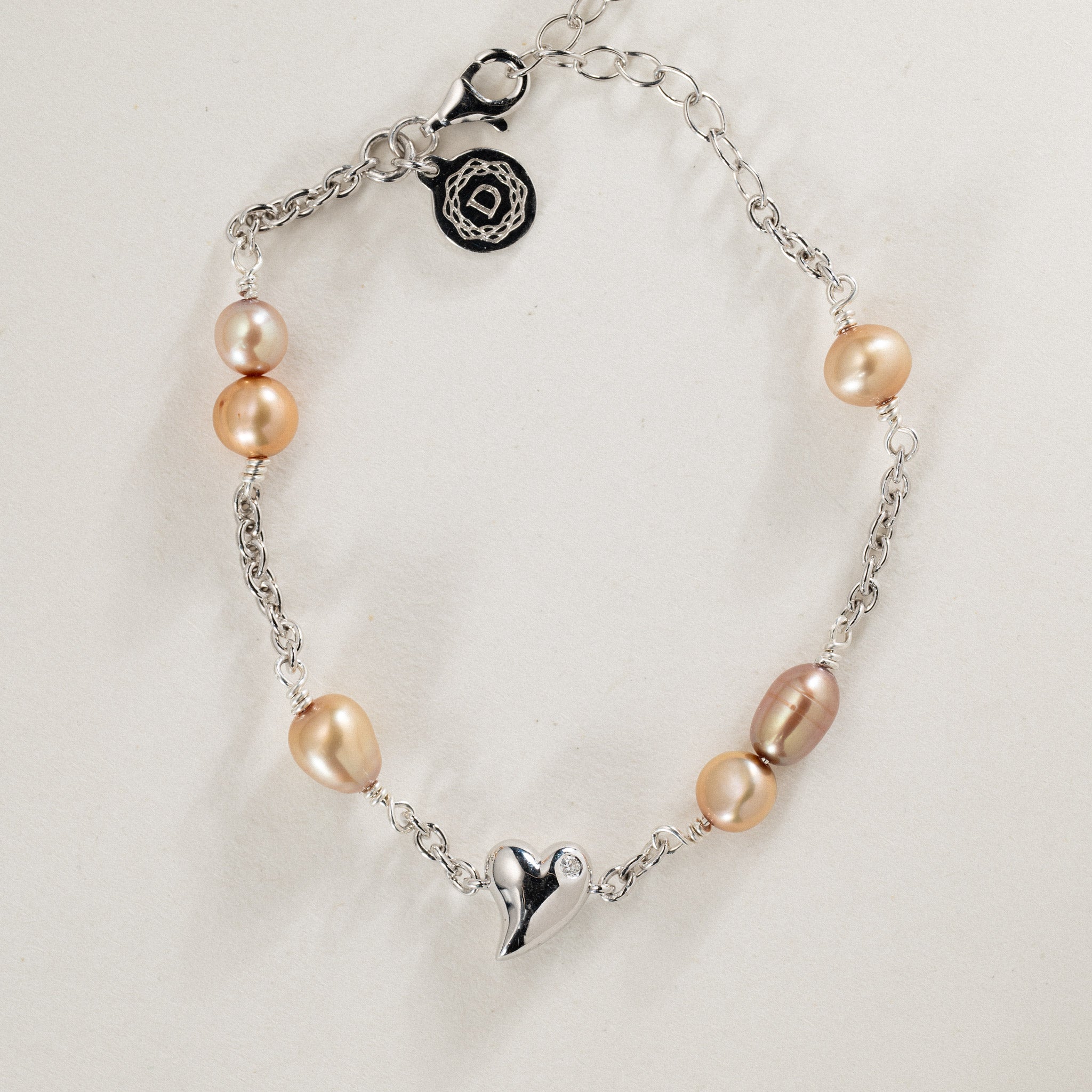 No. 28 - 0.02ct diamond twisted heart bracelet w. freshwater pearls in rhodium silver